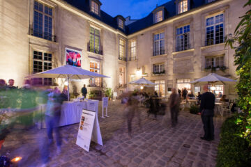 Photo of the animated courtyard of the Institut suédois during an evening event.