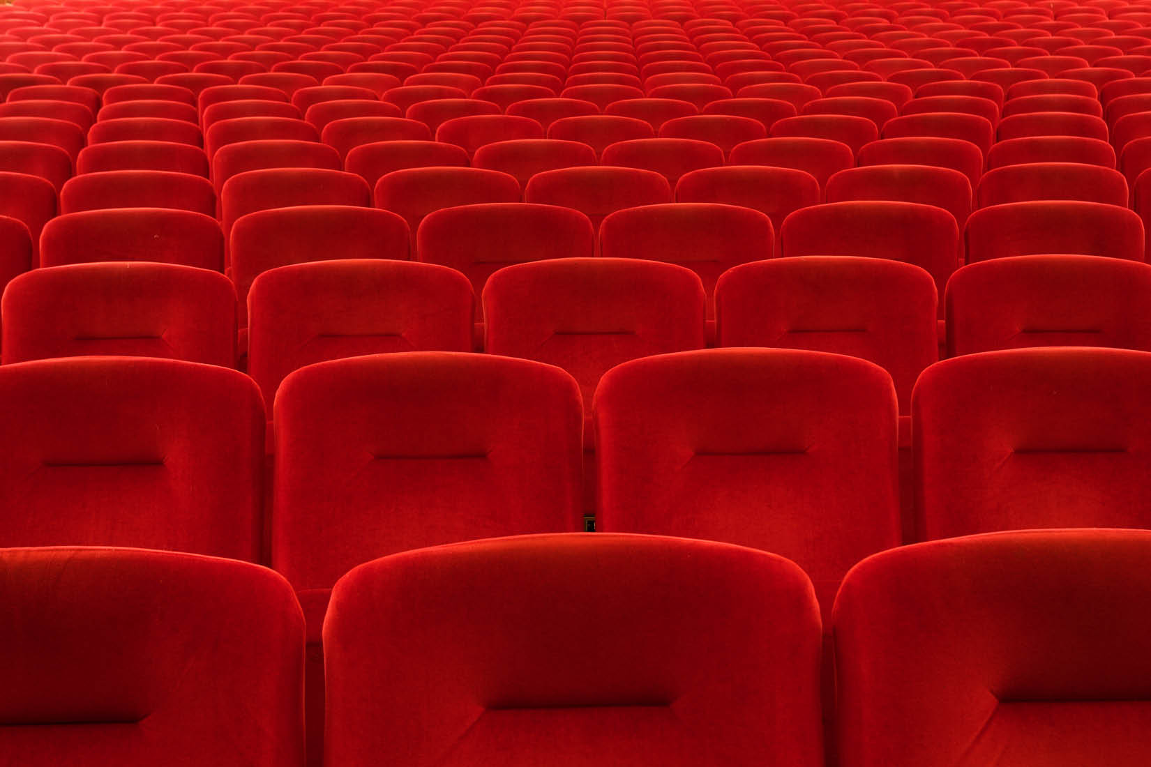 Red cinema seats as far as the eye can see.