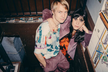 A man and a woman holding each other in the night.